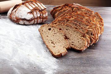 freshly baked bread on wooden board. cutted bread