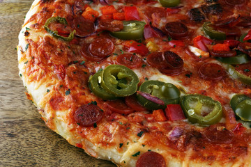 Hot pizza slice with melting cheese on a rustic wooden table. Italien food concept