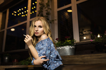 beautiful girl smokes a cigarette