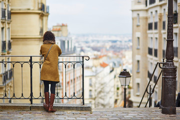Female tourist enjoying city view on a street of Montmartre - obrazy, fototapety, plakaty