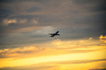 Fototapeta na wymiar Silhouette of airplane at sunset