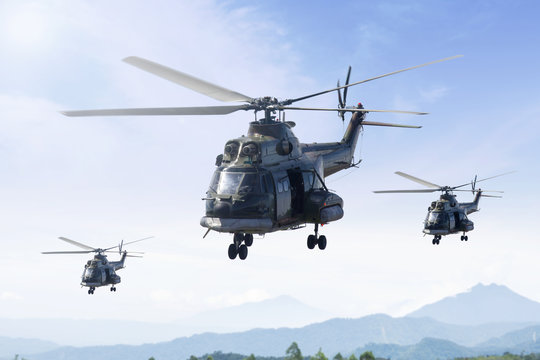 Three military helicopters patrolling in the mountain