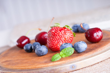 Fresh berries on a wooden cutting board 
