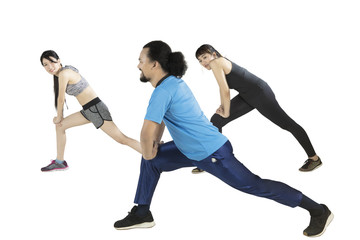 Obraz premium Young friends doing stretching together