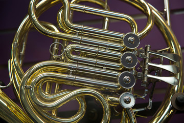 Close up shiny french horn wind musical instrument 