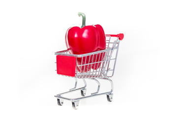 Shopping cart with red bell pepper isolated on white background