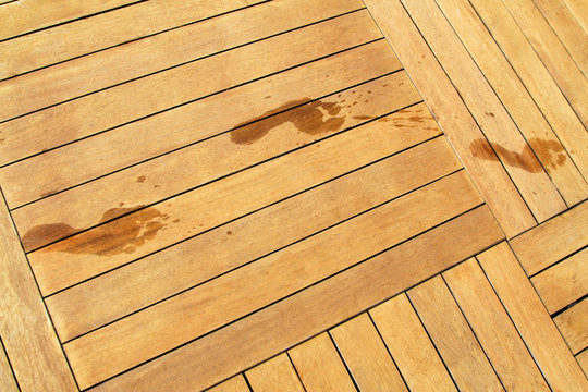 Wet footprints on wood planks,  side the pool. Vacation concept image.