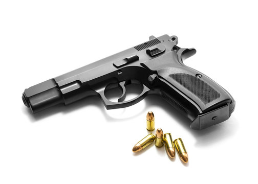 Handgun with ammunition over white background
