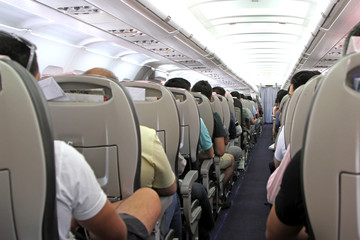 Airplane inside and  passengers 