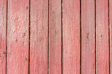 Texture of old wood with worn pink paint