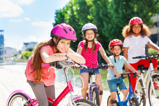 Girl standing with bicycle and waiting for friends