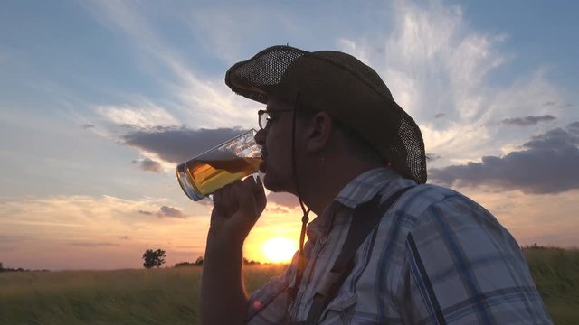 farmer with beer in barley field