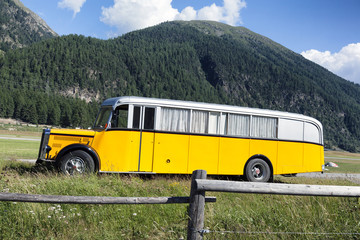 A yellow bus with curtains