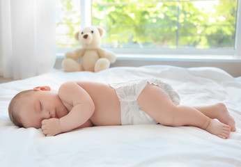 Cute little baby sleeping on bed at home