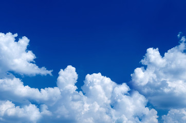 Naklejka na ściany i meble Beautiful sky half-blue, half with fluffy white clouds. Place for text
