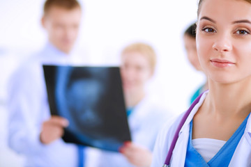 Obraz premium Portrait of young woman doctor with medical stethoscope in white coat standing in hospital
