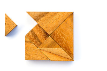 Wooden tangram puzzle in square shape wait for fulfill on white background