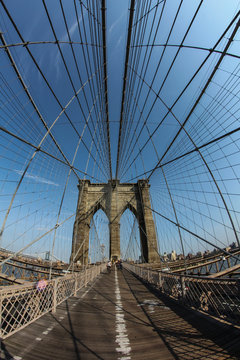 New York City: The Brooklyn bridge connecting the financial district of Manhattan island with Brooklyn is a famous landmark, popular tourist attraction and travel destination