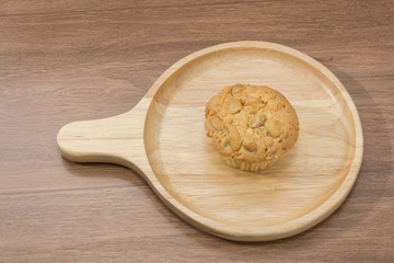cup cake with almond topping on handle round plate
