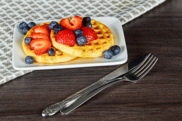 Healthy breakfast: Belgian waffles with sour cream, strawberry, raspberry, blueberry