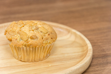 cup cake with almond topping on handle round plate