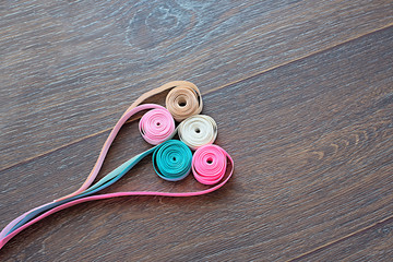 Decorative satin ribbon on dark wooden background