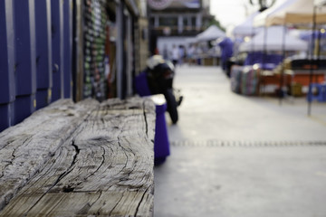 Obraz premium Wooden table top and blurred street market background usage or create montage.
