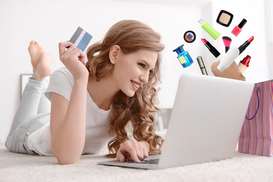 Young woman shopping online with credit card and laptop at home