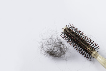 Round hair brush with lost hair on white background.