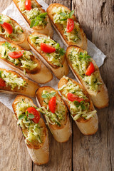 Dietary bruschetta with zucchini and tomatoes closeup on the table. Vertical top view
