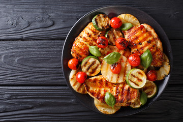Chicken fillet grilled with vegetables in a sweet-hot sauce close-up. horizontal top view