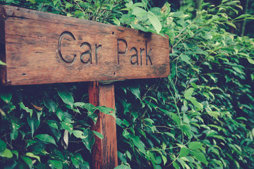 Label Wooden Car Park on Green leaf background