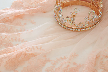 Vintage tulle pink chiffon dress and diamond tiara on wooden white table © tomertu