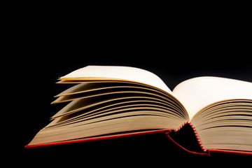 Vintage old open book on black background