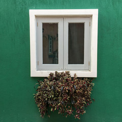 European style window with sand wall background