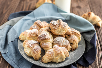  Croissants with chocolate filling on a wooden background
