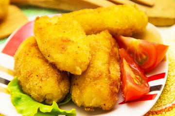 Plate of croquettes with lettuce and tomato