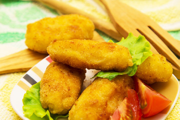 Plate of croquettes with lettuce and tomato