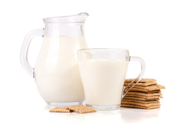 Obraz na płótnie Canvas jug and glass of milk with stack of grain crispbreads isolated on white background