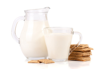 jug and glass of milk with stack of grain crispbreads isolated on white background