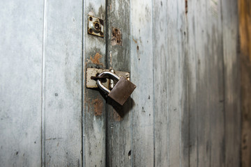 Closeup of old wooden door with metal lock