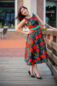 Stylish vintage young woman in retro dress 50s style, walk in old town. Vintage style in everyday modern life. Perfect american housewife