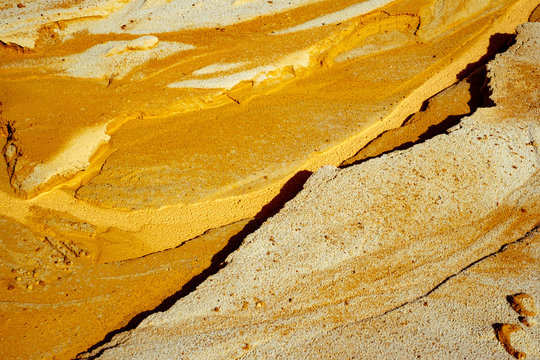 Abstract golden sand texture on the beach, closeup view