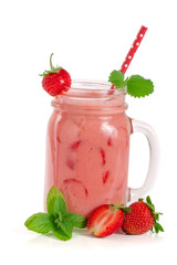 Glass of strawberry yogurt or smoothie with mint leaves isolated on white background