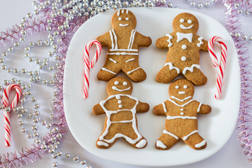 Christmas gift. Christmas composition. Homemade Xmas Cookies Gingerbread Man. Blurred light new year tree background