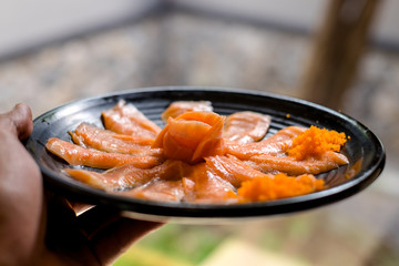 Fresh salmon slide with black plate
