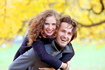 Couple having fun in autumn park