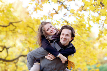 Couple having fun in autumn park