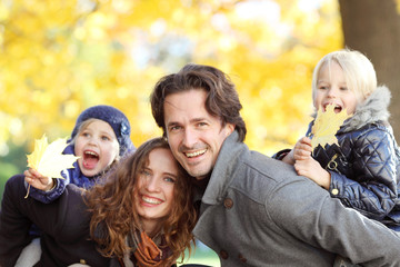 Parents giving children piggyback ride