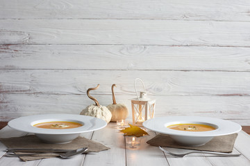 Romantic halloween dinner with pumpkin soup, festive serving